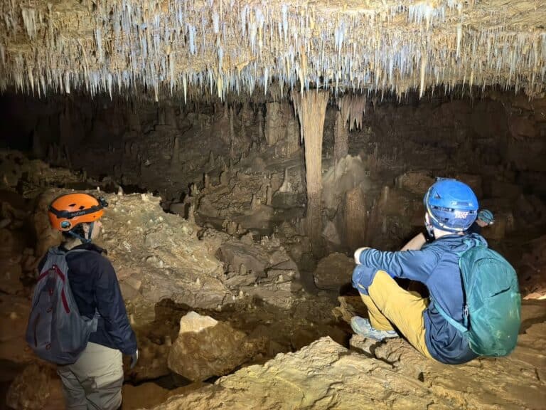Two cavers admiring formations